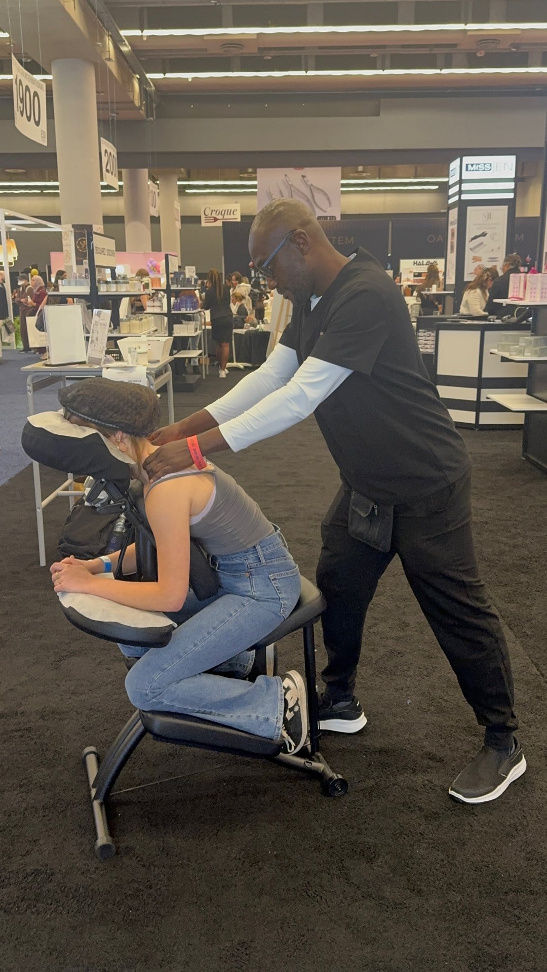 Praticien AmaniTouch offrant un massage sur chaise lors de l’Esthétique Spa International Montréal 2026.